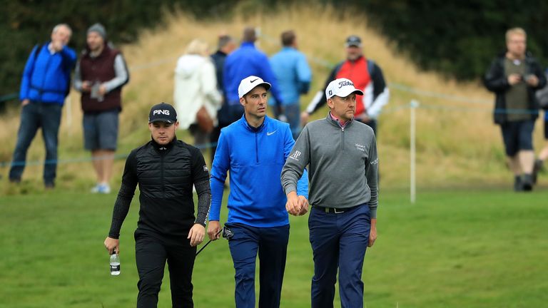 Tyrell Hatton, Ross Fisher and Ian Poulter of England walk up the 14th hole during day two of the British Masters