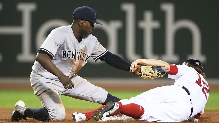 BOSTON, MA - AUGUST 19:  Brock Holt #12 of the Boston Red Sox is tagged out while trying to steal second base by Didi Gregorius #18 of the New York Yankees