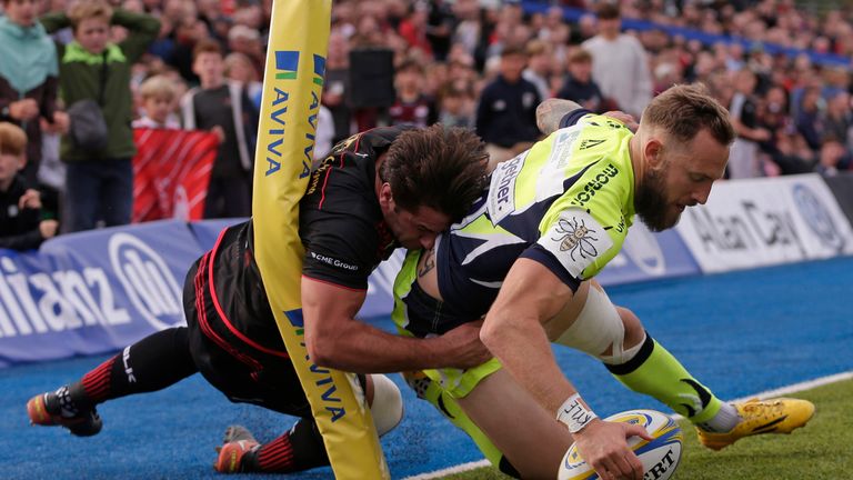  Byron McGuigan scores despite the tackle of  Henry Taylor 