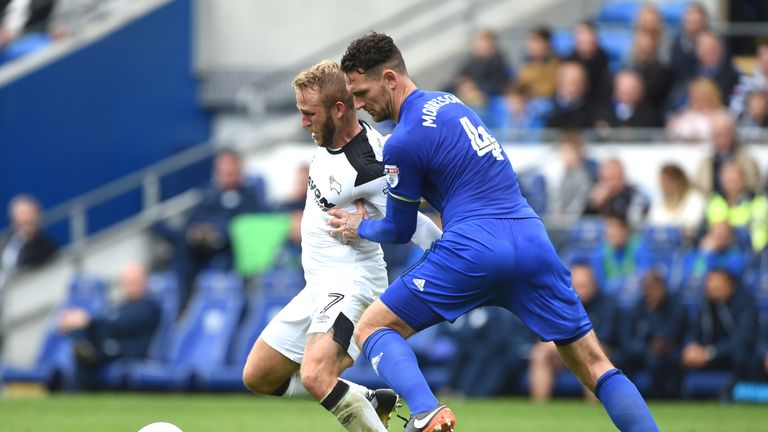 Sean Morrison and Johnny Russell battle for the ball during the Sky Bet Championship match at Cardiff City Stadium