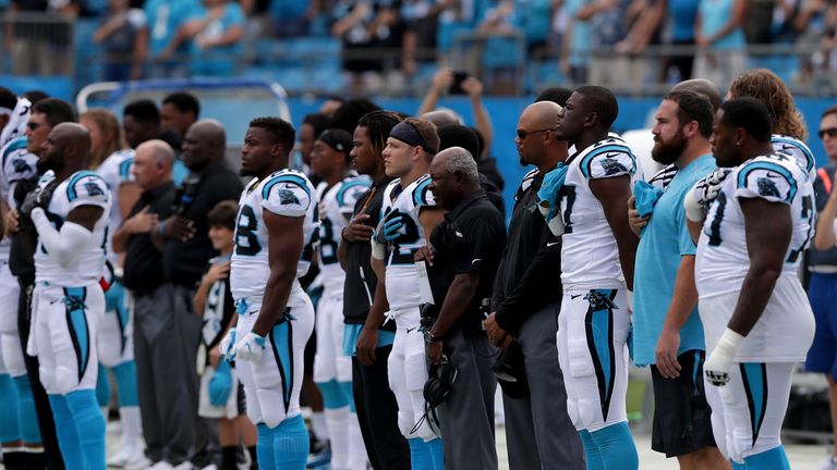 CHARLOTTE, NC - SEPTEMBER 24:  The Carolina Panthers stand during the National Anthem before their game against the New Orleans Saints at Bank of America S