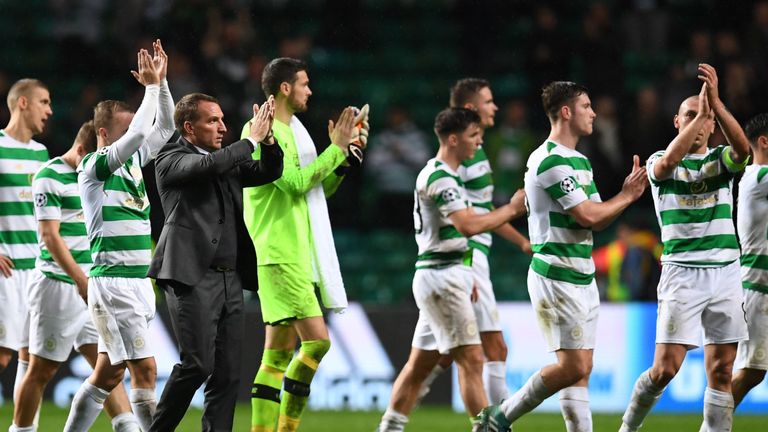 Celtic's Northern Irish manager Brendan Rodgers (3rd L) and players applaud supporters on the pitch after the UEFA Champions League Group B football match 