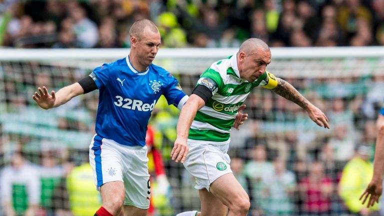 23/04/17: Celtic captain Scott Brown is challenged by Rangers striker Kenny Miller (left)