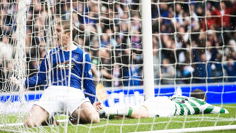 Steven Davis celebrates as he slides into the net after his winner for Rangers against Celtic. 