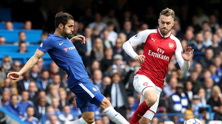 Chelsea's Cesc Fabregas (left) and Arsenal's Aaron Ramsey battle for the ball during the Premier League match at Stamford Bridge, London.