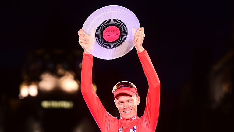 Chris Froome raises the trophy aloft in Madrid on Sunday night
