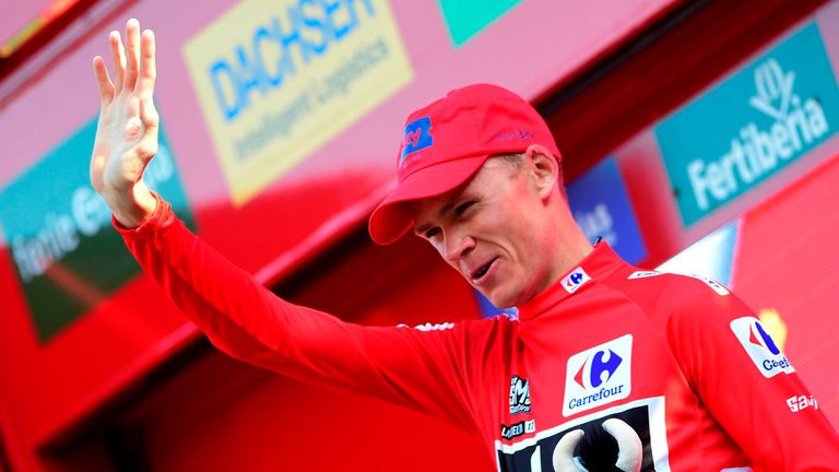 Christopher Froome celebrates after retaining the red jersey