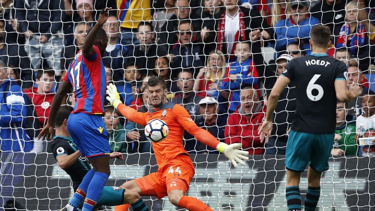 Southampton goalkeeper Fraser Forster (2R) saves a shot from Crystal Palace's striker Christian Benteke (2L)