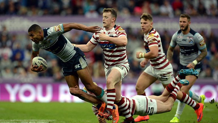 Kallum Watkins (L) of Leeds Rhinos tackled by Connor Farrell (C) and Dan Sarginson of  Wigan during the Super League match on May 30, 2015 in Newcastle