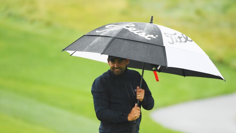 PRAGUE, CZECH REPUBLIC - SEPTEMBER 01:  Lee Slattery of England shelters from the rain on the 15th green during day two of the D+D REAL Czech Masters at Al