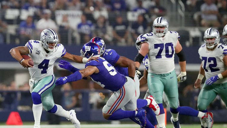 Dak Prescott evades Olivier Vernon in the second quarter at the AT&T Stadium