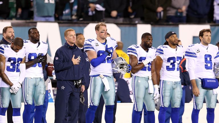 PHILADELPHIA, PA - DECEMBER 14:  Jason Garrett head coach of the Dallas Cowboys lines up with his team during the national anthem prior to the game against