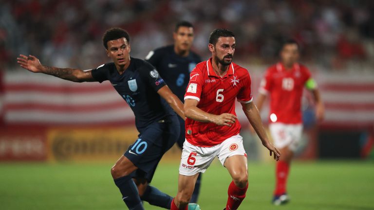 Malta's Ryan Fenech evades Dele Alli of England 