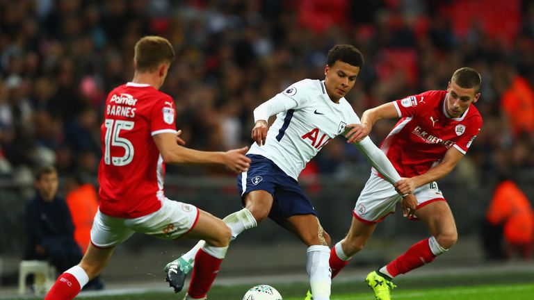 LONDON, ENGLAND - SEPTEMBER 19:  Dele Alli of Tottenham Hotspur and Joe Williams of Barnsley battle for possession during the Carabao Cup Third Round match