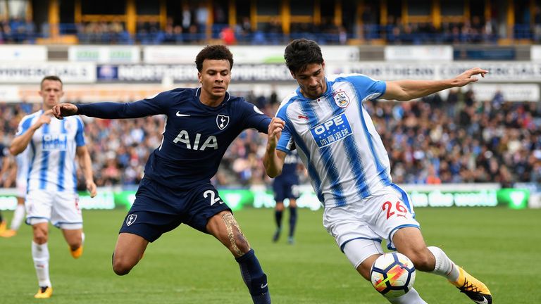 Dele Alli (left) was booked for simulation during Spurs' 4-0 win at Huddersfield