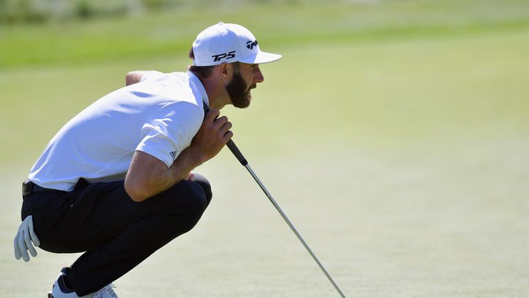 Dustin Johnson of the United States lines up a putt on the ninth green during round one of the Dell Technologies Championship