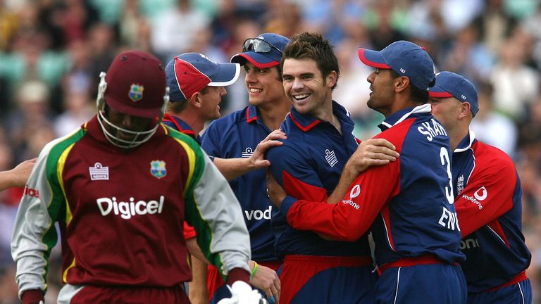 , UNITED KINGDOM: England's James Anderson (C) celebrates with team mates after taking West Indies batsman Chris Gayle's (L) wicket