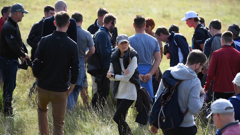 Erica McIlroy helps look for husband Rory McIlroy's ball on the 17th hole during day one of the British Masters