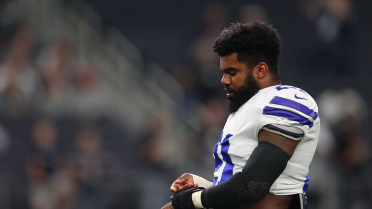 Ezekiel Elliott #21 of the Dallas Cowboys wraps his hands on the field during warm-ups in a preseason game against the Oakland Raiders on August 26