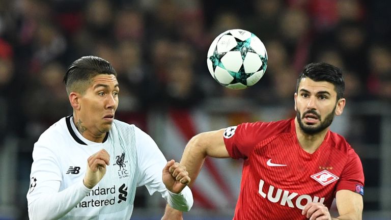 Liverpool's forward from Brazil Roberto Firmino (L) and Spartak Moscow's defender from Germany Serdar Tasci vie for the ball during the UEFA Champions Leag