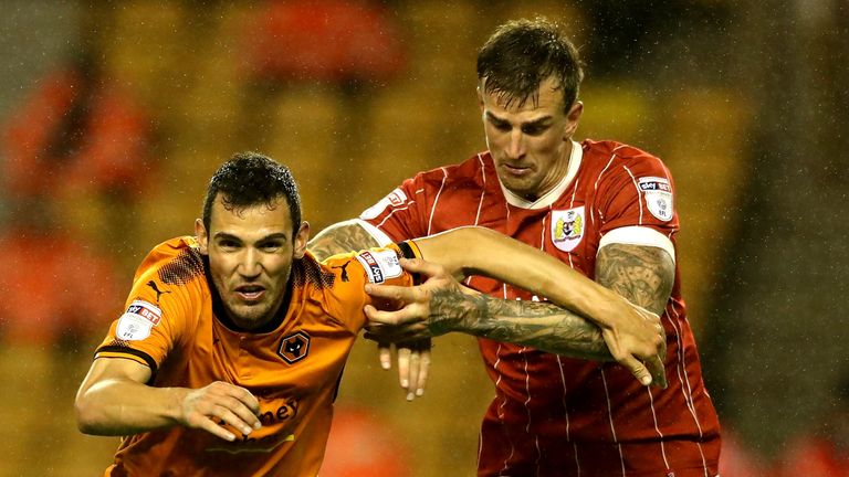 Leo Bonatini (L) is challenged by Aden Flint at Molineux