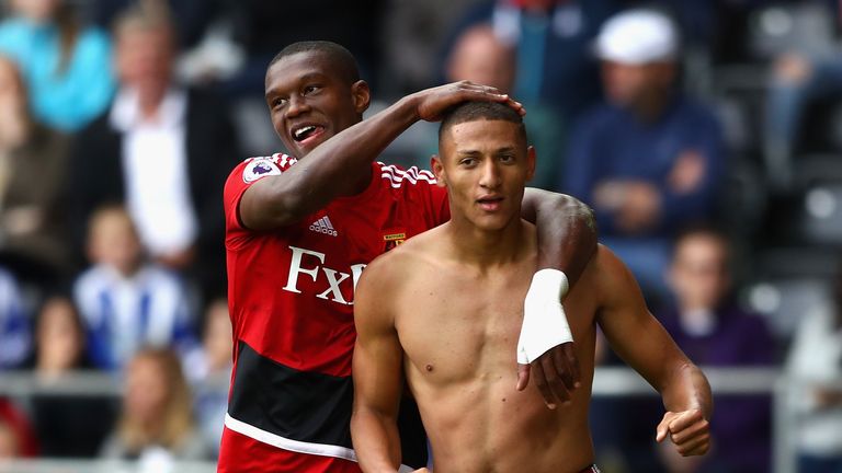 SWANSEA, WALES - SEPTEMBER 23:  Richarlison de Andrade (R) of Watford celebrates scoring his side's second goal with his team mate Christian Kabasele (L) d