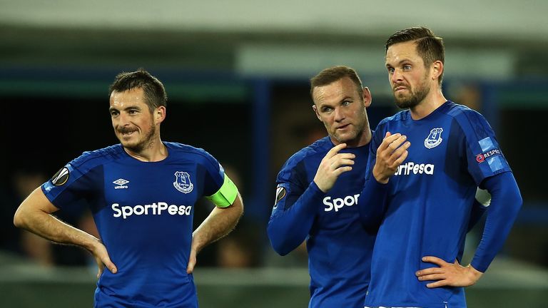LIVERPOOL, ENGLAND - SEPTEMBER 28:  Leighton Baines of Everton (L) looks on as Wayne Rooney (C) and Gylfi Sigurdsson discuss a freekick during the UEFA Eur