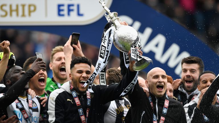 Newcastle United players Jamaal Lascelles and Jonjo Shelvey lift the Sky Bet EFL trophy