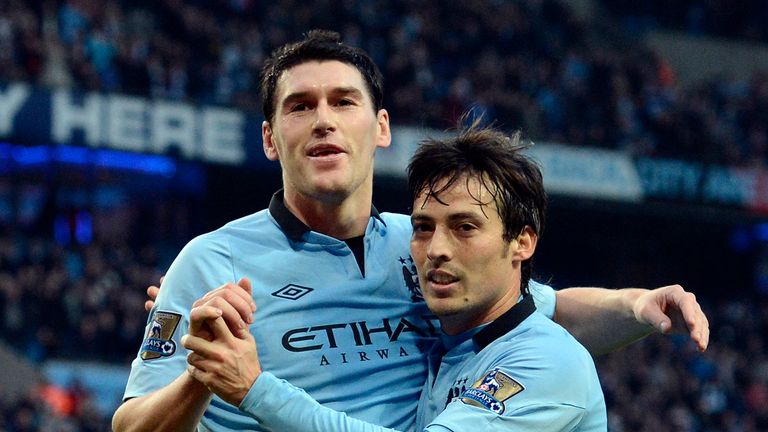Manchester City's English midfielder Gareth Barry (L) celebrates with Manchester City's Spanish midfielder David Silva (R) after scoring the second goal du