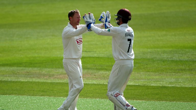 Surrey's Gareth Batty celebrates with team mate Ben Foakes after taking the wicket of Yorkshire's Tim Bresnan