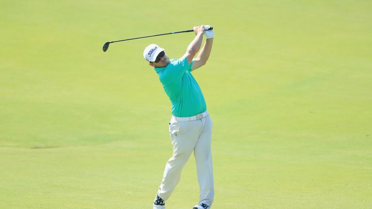 George Coetzee of South Africa plays his second shot on the fifth hole during the third round of the Portugal Masters