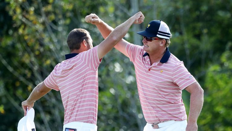 JERSEY CITY, NJ - SEPTEMBER 29:  Kevin Chappell and Charlie Hoffman of the U.S. Team celebrate on the 13th green after defeating Anirban Lahiri of India an