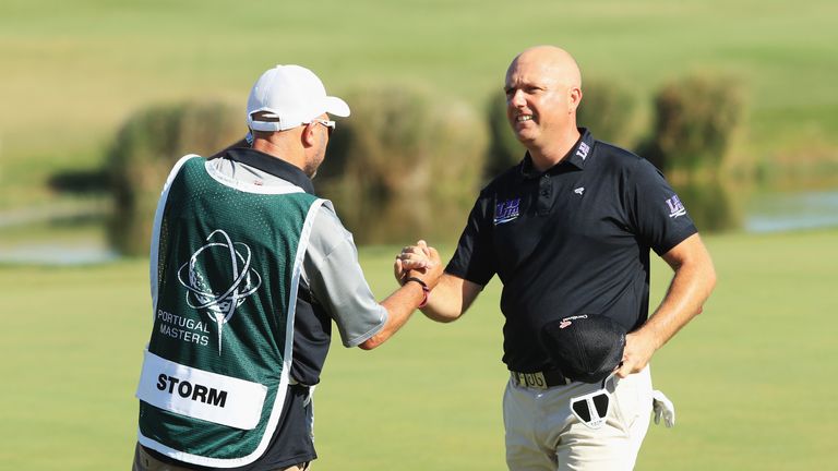 ALBUFEIRA, PORTUGAL - SEPTEMBER 24:  Graeme Storm of England celebrates on the 18th green with his caddie during day four of the Portugal Masters at Dom Pe