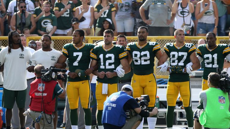 Members of the Green Bay Packers stand with arms locked as sign of unity during national anthem ahead of Cincinnati Bengals game at Lambeau Field on Sep 24