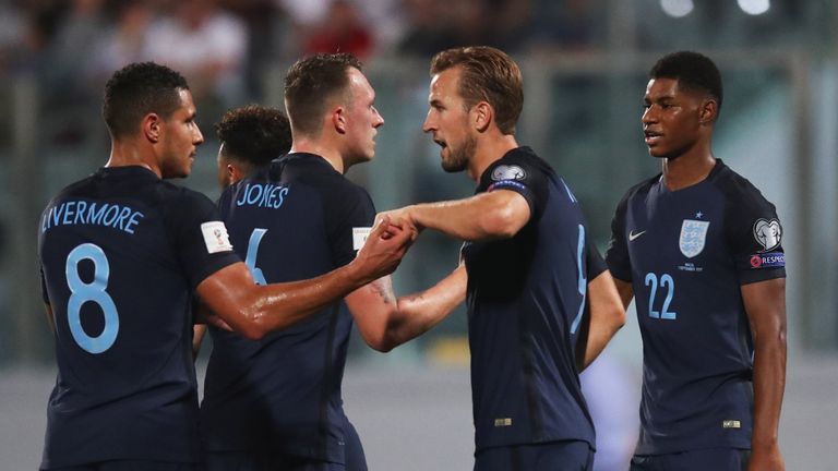 Harry Kane of England (2R) celebrates as he scores their first goal with Jake Livermore (8) during the FIFA 2018 World Cup