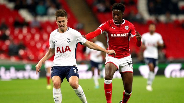 Barnsley's Ike Ugbo (right) and Tottenham Hotspur's Juan Foyth (left) battle for the ball during the Carabao Cup, third round match at Wembley Stadium