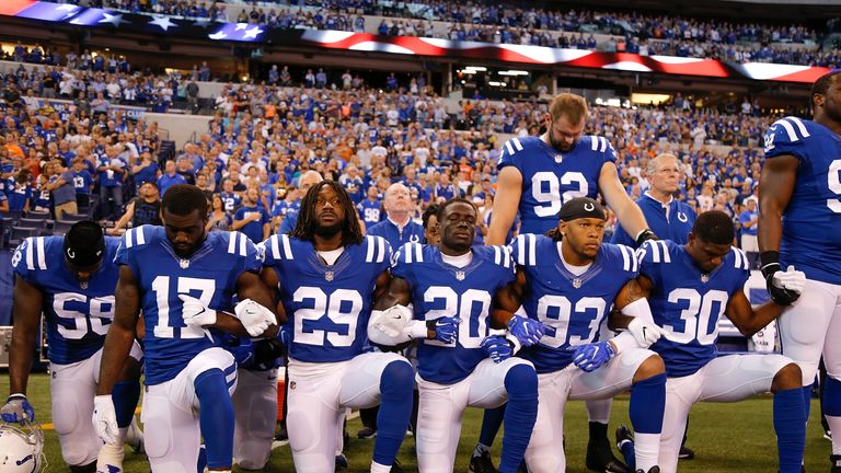 INDIANAPOLIS, IN - SEPTEMBER 24:  Members of the Indianapolis Colts stand and kneel for the national anthem prior to the start of the game between the Indi