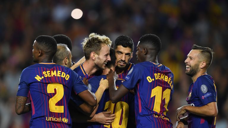 BARCELONA, SPAIN - SEPTEMBER 12: Ivan Rakitic of Barcelona celebrates scoring his sides second goal with his Barcelona team mates during the UEFA Champions