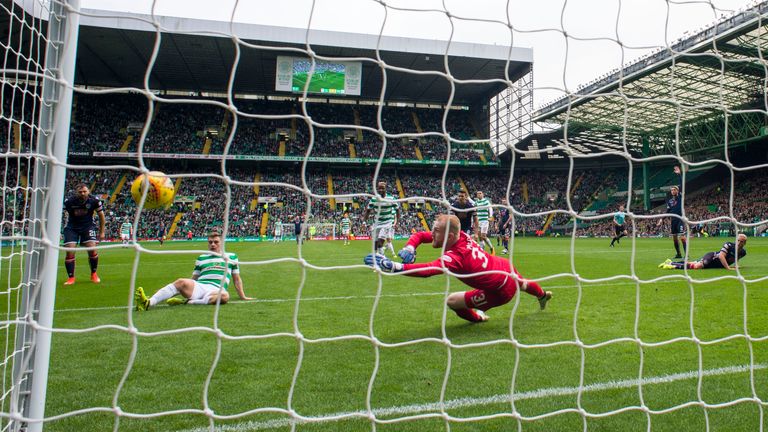 James Forrest (grounded left) scored the third goal for the champions