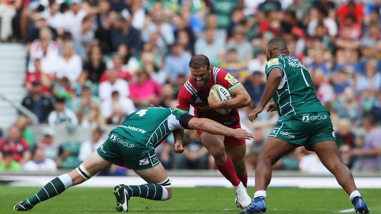Jamie Roberts of Harlequins is tackled by Franco van der Merwe and Danny Hobbs-Awoyemi of London Irish 