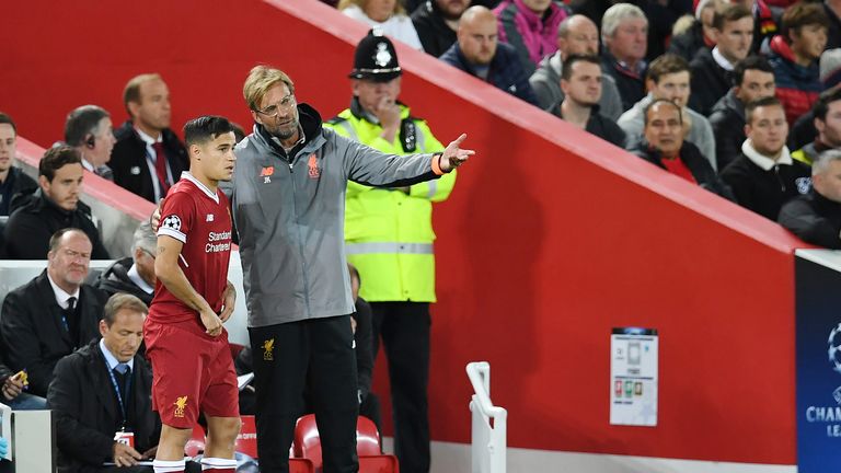Jurgen Klopp speaks to Philippe Coutinho as he prepares to as he prepares to come on against Sevilla at Anfield