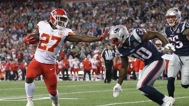 FOXBORO, MA - SEPTEMBER 07:  Kareem Hunt #27 of the Kansas City Chiefs stiff arms Duron Harmon #30 of the New England Patriots as he runs for a 4-yard rush