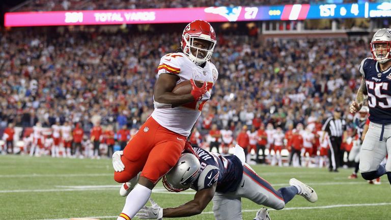 Kareem Hunt #27 of the Kansas City Chiefs runs for a 4-yard rushing touchdown as Duron Harmon #30 of the New England Patriots 