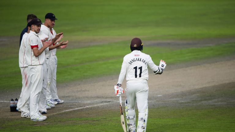 MANCHESTER, ENGLAND - SEPTEMBER 27: Lancashire players clap Kumar Sangakkara of Surrey as he walks onto the pitch for the last time during the County Champ