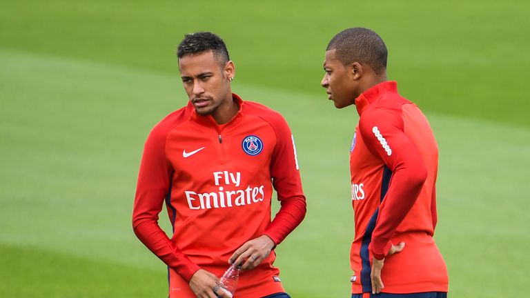 Paris Saint-Germain's French forward Kylian Mbappe (R) and Paris Saint-Germain's Brazilian forward Neymar speak during a training session at the Ooredoo - 