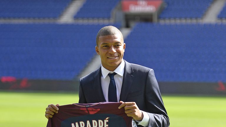 Kylian Mbappe poses for the media at Parc des Princes after making the switch from Ligue 1 rivals Monaco