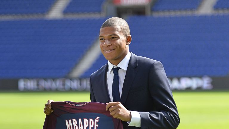Kylian Mbappe poses for the media at Parc des Princes during his unveiling in Paris