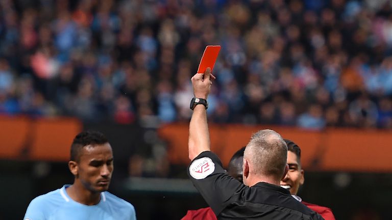 Referee Jon Moss shows a red card to Sadio Mane (C) for a dangerous play