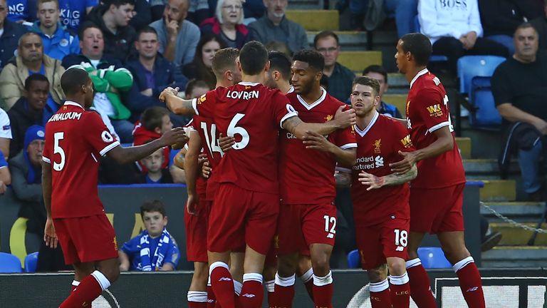 Mohamed Salah is mobbed by his team-mates after opening the scoring against Leicester