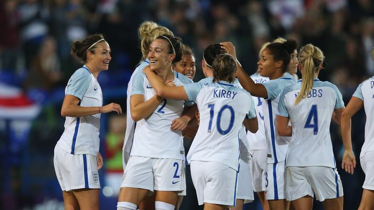 Lucy Bronze is congratulated by team-mates after scoring England's fourth